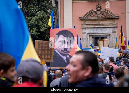 Picture of Poster of Vladimir Putin Characterized as Aldolf Hitler at a Ukrainian Anti-War Demonstration. Concept of Nazi dictator, Putler of Russia Stock Photo