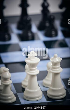 Black and white chess pieces on chessboard Stock Photo