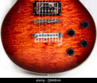 A Epiphone Gibson Les Paul guitar in sunburst cherry , showing body, fretboard. Stock Photo