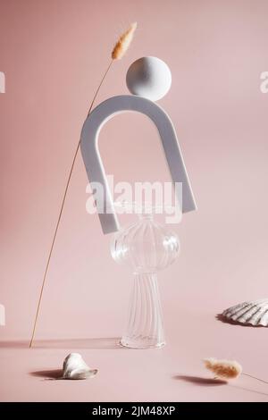 balance composition from different items. vase , arch and textured shell on beige background. still life, abstract modern art design concept. Stock Photo