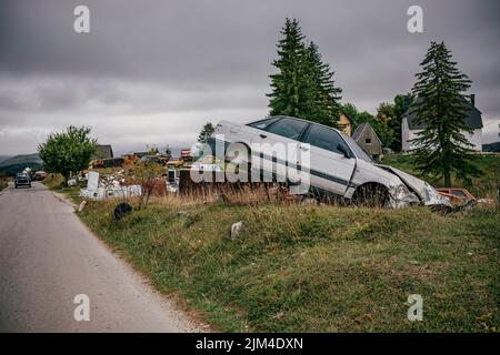 The car scrapyard on the roadside in Montenegro. Stock Photo