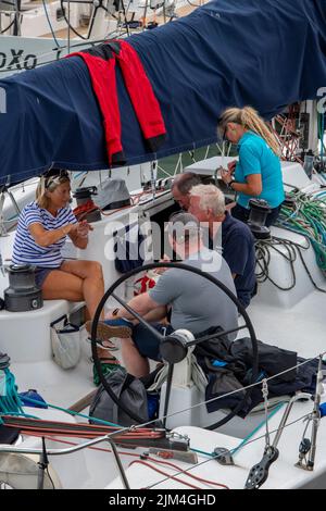 crews in cowes yacht haven waiting to start racing in the annual cowes week yachting or sailing regatta after a postponement due to light winds, cowes Stock Photo