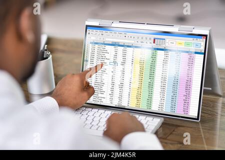 African American Analyst Using Spreadsheet On Screen Stock Photo