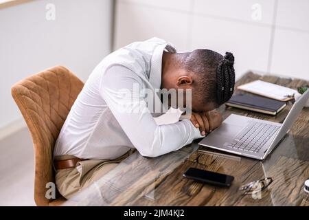Banner Of Tired African Businessman Sleeping In Office Stock Photo