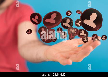 A group of 3D rendered profile icons hovering over a man's hand Stock ...