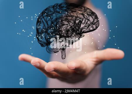 A person's hand with an illustrative brain floating above hands ...