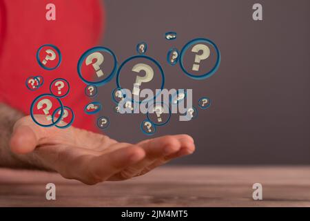 A man presenting 3D rendered question marks Stock Photo