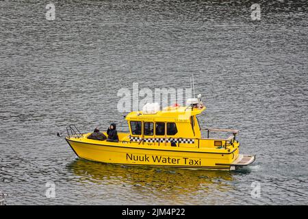 Bright yellow Water Taxi in  Nuuk  harbour, Nuuk, Greenland on 20 July 2022 Stock Photo