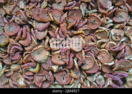 abstract dry apple pieces pile closeup, natural food background diversity Stock Photo