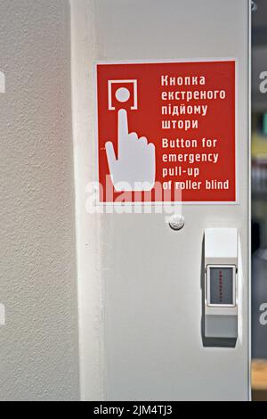 red button for emergency roller pull-up message closeup on the wall, modern security diversity Stock Photo
