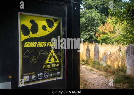 Southampton, UK. 4th of August 2022. 'Grass fires kill' sign during extremely dry conditions during a summer drought at Southampton Old Cemetery in Hampshire, warning of increased fire risk, UK Stock Photo