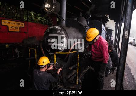 June 11, 2022, Darjeeling, West Bengal, India: The steam engines of UNESCO World Heritage Site Darjeeling Himalayan Railway ''toy train''-s at the Darjeeling loco shed preparing for the early morning haul in Darjeeling, West Bengal, India on 11/06/2022. It is also considered to be the world's 22nd highest railway. Darjeeling Himalayan Railways may conduct up to 20 train rides. The trains are pulled by old-style coal-fired engines. Coal ashes fly there all the time, and Locomotive Mechanics are working all day in this polluted air. (Credit Image: © Soumyabrata Roy/Pacific Press via ZUMA Press W Stock Photo