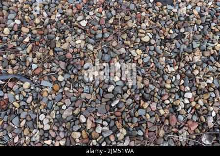 A top view of colorful pebbles, and twigs Stock Photo