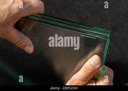Toughened glass, protection of the glass pane in a special furnace, Inscription denoting ready and protected material against easy breakage. Glass ind Stock Photo