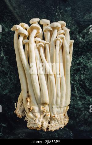 a bunch of white enoki, seafood mushrooms grown in China, a popular ingredient for soups, especially in East Asian cuisine Stock Photo