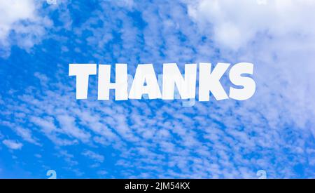 The word Thanks written on blue sky Stock Photo
