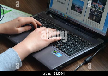 A closeup of a person's hands working on the computer Stock Photo