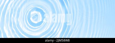 The surface of light on the light blue transparent swimming pool water background. Abstract wavy background. Water waves in sunlight banner. Trendy Stock Photo
