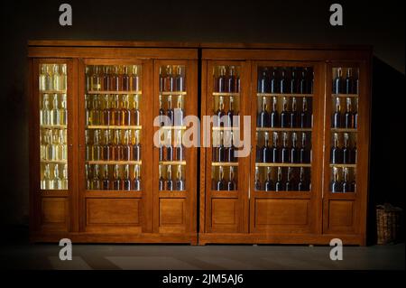 Different ages and colours of strong alcoholic apple drink calvados in Normandy, Calvados region, France, calvados tasting tour Stock Photo