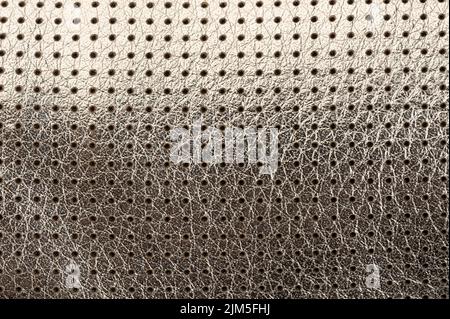 Shiny metal leather perforated background macro close up view Stock Photo