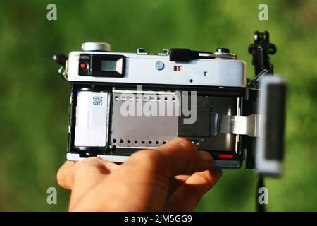 Hand holding rear view analog camera with negative film on in Stock ...