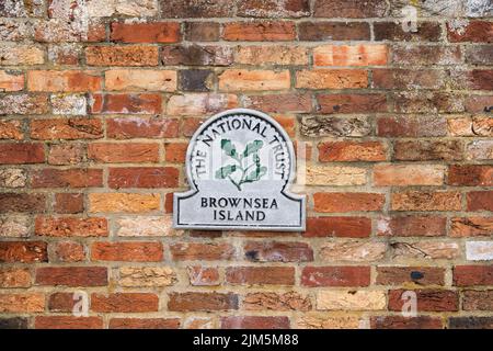 Poole, Dorset, United Kingdom - April 14 2022: National Trust Brownsea Island plaque mounted on the outer walls of the island Stock Photo