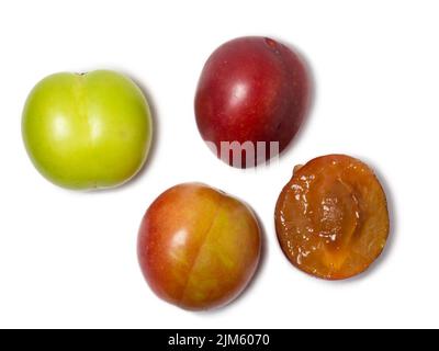 Cherry plum at different stages of maturation. Plum variety. Red and green fruits. Tkemali. Isolate of several species of the same fruit. Sliced fruit Stock Photo