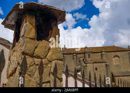 27,04,2022 ronda,malaga,spain closeup of a typical chimney with the church of the holy spirit in the background Stock Photo