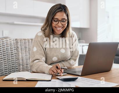 Working from home has been good to me. a beautiful young woman working from home. Stock Photo