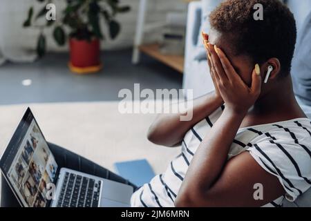 African woman having issues with project, working remotely. Girl disappointed with overspending, high fees. Stock Photo