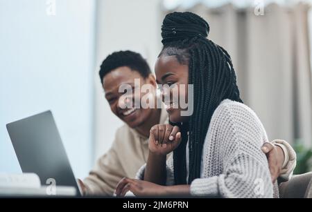 Self quarantine with my favourite study buddy. a happy young couple working from home. Stock Photo