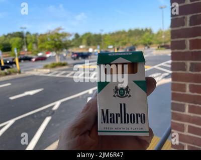 Augusta, Ga USA - 04 29 22: Hand holding Marlboro menthol Stock Photo