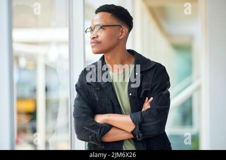 Dont listen to doubt, it doesnt know whats best for you. a confident young businessman looking thoughtful in a modern office. Stock Photo