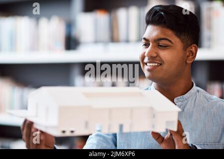 Architects give art a function. a young architect designing a building model in a modern office. Stock Photo