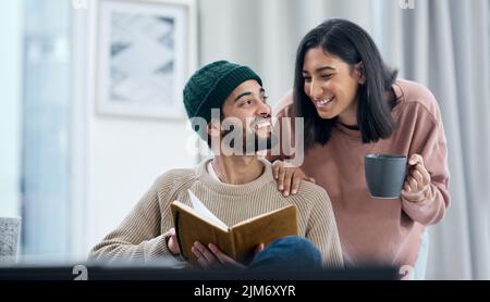 Reaching their goals from the comfort of home. a young couple going over notes together while working from home. Stock Photo