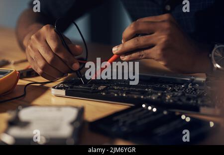 Nothing is too faulty for his expert hands. an unrecognisable technician repairing computer hardware. Stock Photo