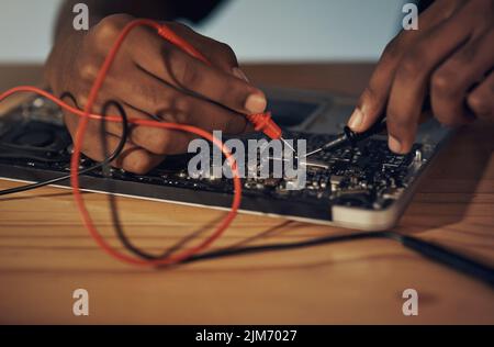 It wont be long before your laptop is fixed. an unrecognisable technician repairing computer hardware. Stock Photo