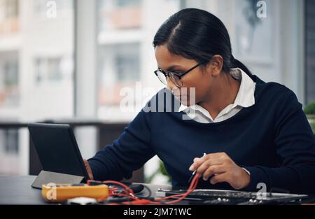 The best technology to fix any technology. a young technician using a digital tablet while repairing computer hardware. Stock Photo