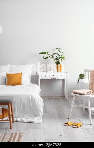 Interior of light bedroom with table and chair Stock Photo