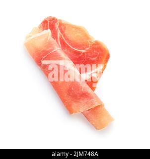 Rolled slice of jamon on white background Stock Photo