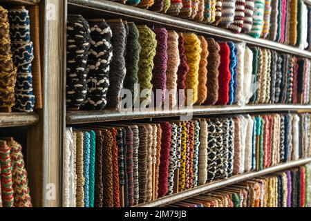 multi-colored braid on the counter of the store for decoration, sewing and needlework Stock Photo
