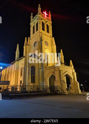 A vertical shot of the Christ Church against black night sky in Shimla, Himachal Pradesh, India Stock Photo