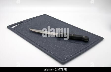 Cutting board with knife isolated on white background Stock Photo