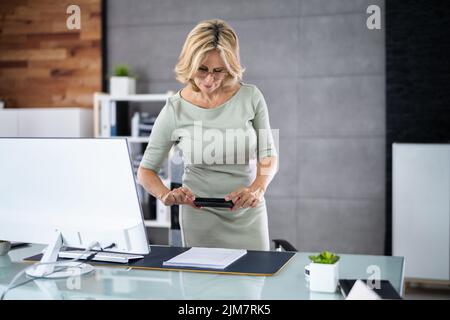 Taking Document Picture Or Photo With Phone. Smartphone Optical Document Stock Photo