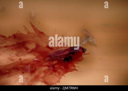 broken glass with red wine on pink background with copy space Stock Photo