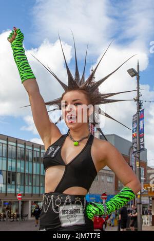 American model, SAG-AFTRA actress, wardrobe stylist, TV host. fashion designer,  with Mohican style, dyed hair and colouring at the Punk Rebellion festival at The Winter Gardens. A protest against conventional attitudes and behaviour, a clash of anti-establishment cultures,  mohawks, safety pins and a load of attitude at the seaside town as punks attending the annual Rebellion rock music festival at the Winter Gardens come shoulder to shoulder with traditional holidaymakers. Stock Photo