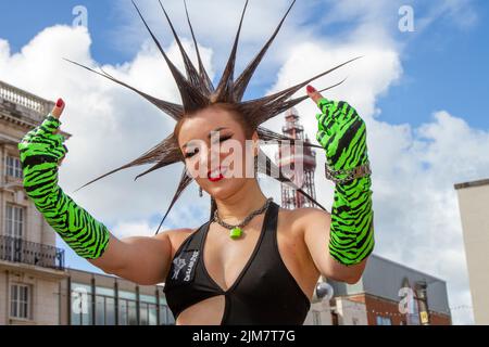 American model, SAG-AFTRA actress, wardrobe stylist, TV host. fashion designer,  with Mohican style, dyed hair and colouring at the Punk Rebellion festival at The Winter Gardens. A protest against conventional attitudes and behaviour, a clash of anti-establishment cultures,  mohawks, safety pins and a load of attitude at the seaside town as punks attending the annual Rebellion rock music festival at the Winter Gardens come shoulder to shoulder with traditional holidaymakers. Stock Photo