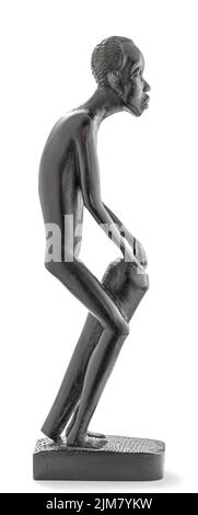 Wooden African statue of a skinny man working playing percussion, isolated on white Stock Photo