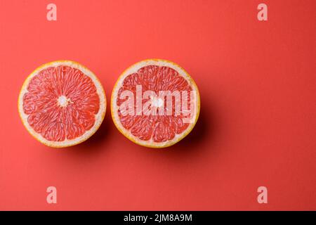 Closeup view of grapefruit on a red background Stock Photo