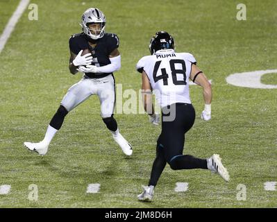 Las Vegas Raiders' Tyron Johnson (17) runs against the Los Angeles Chargers  during the first half of an NFL football game, Sunday, Jan. 9, 2022, in Las  Vegas. (AP Photo/Ellen Schmidt Stock